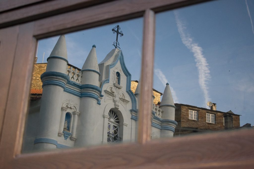 church-reflection-in-window-piodao-portugal