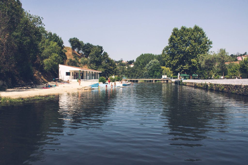 river-beach-with-white-building-and-trees-portugal
