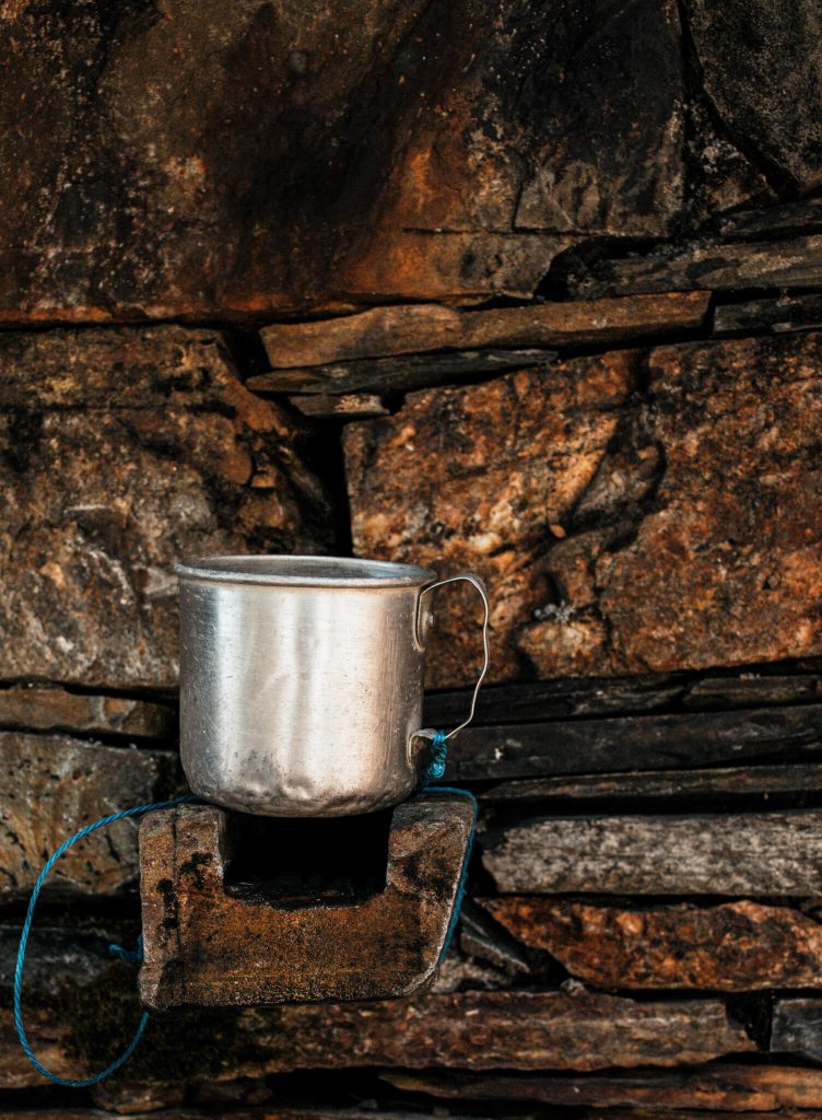 rustic-metal-cup-on-slate-wall-schist-village-portugal